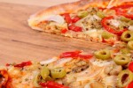 Fresh baked vegetarian pizza ready to eat on wooden table, italian cuisine, concept of fast food